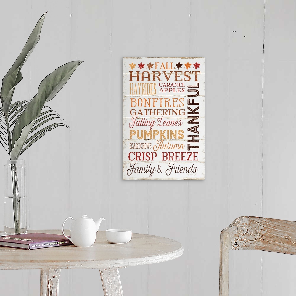 A farmhouse room featuring Thanksgiving themed typography artwork in festive fall colors against a rustic wooden background.