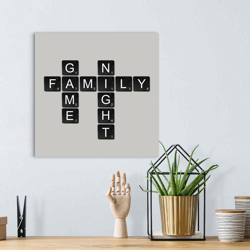 A bohemian room featuring "Family Game Night" spelled out in black and white scrabble tiles.