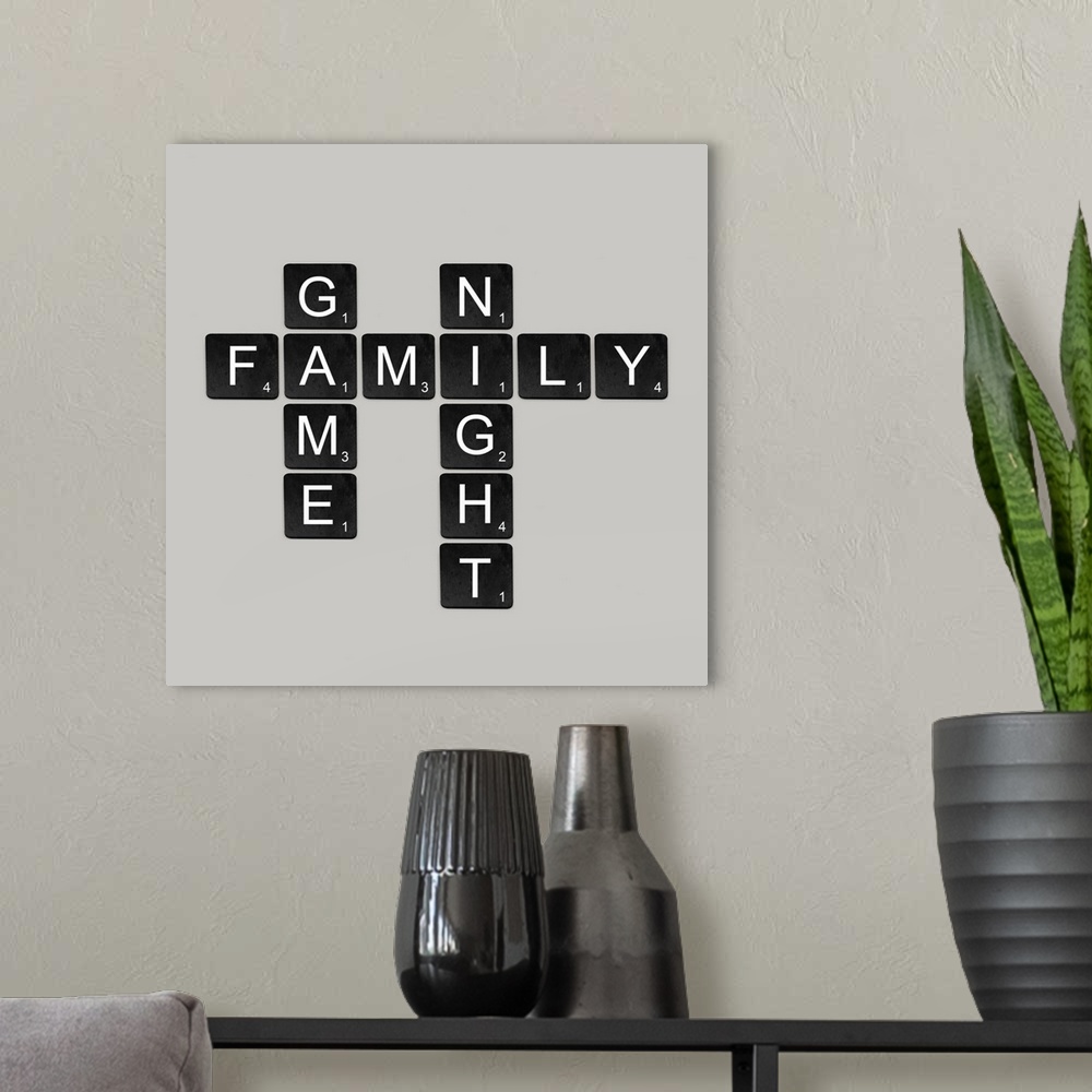 A modern room featuring "Family Game Night" spelled out in black and white scrabble tiles.