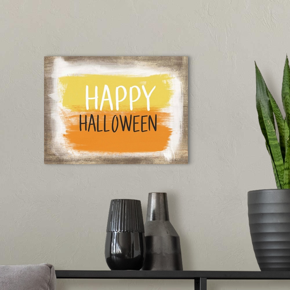 A modern room featuring Halloween typography artwork with a painted wooden board effect in yellow and orange.