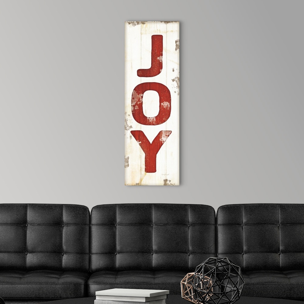 A modern room featuring Christmas themed typography artwork in festive seasonal colors against a distressed background.