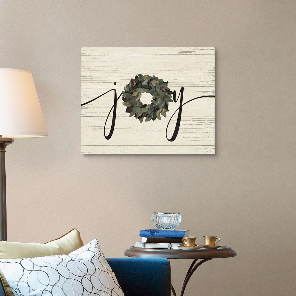 A traditional room featuring A decorative painting of the word "Joy" with a wreath on a wood paneled background.