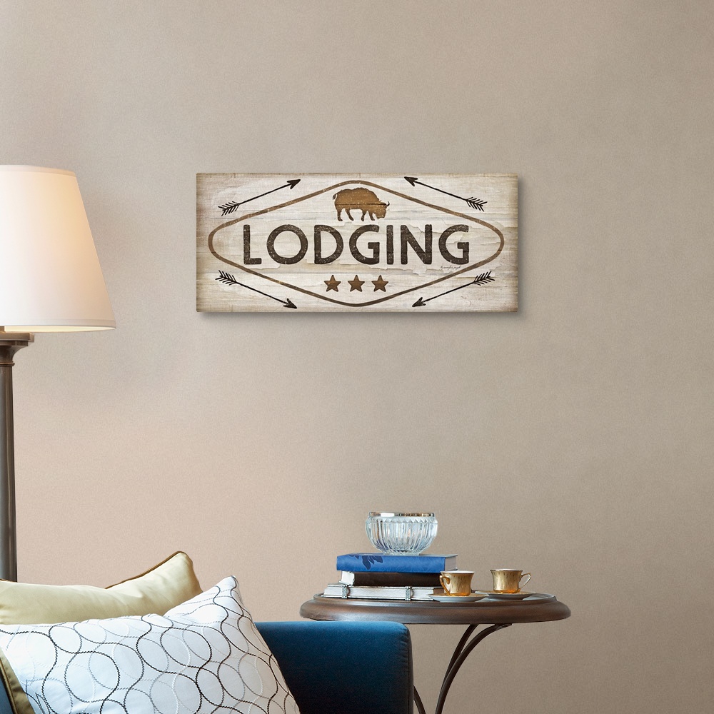 A traditional room featuring Contemporary cabin decor artwork of a wooden sign for Lodging.