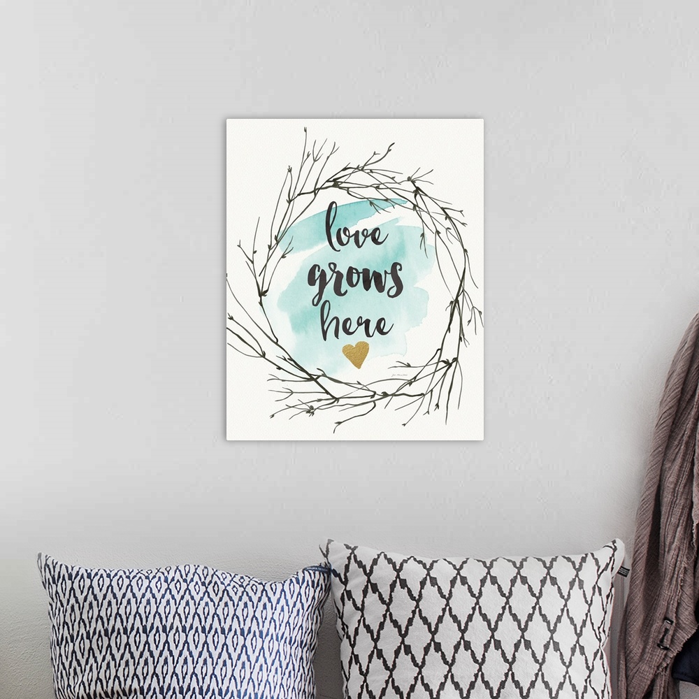 A bohemian room featuring A decorative typographic design in the center of a wreath of twigs.