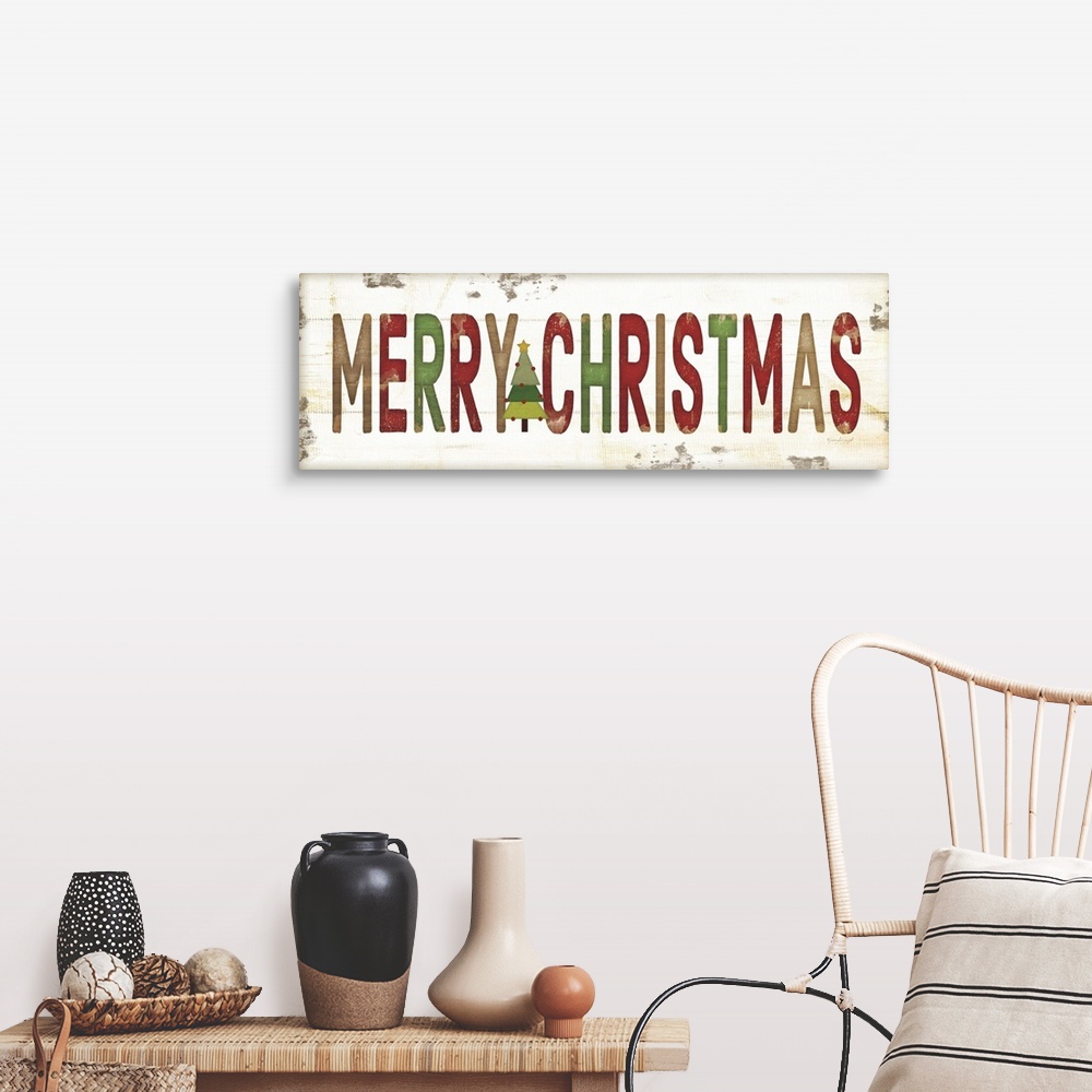 A farmhouse room featuring Christmas themed typography artwork in festive seasonal colors against a distressed background.