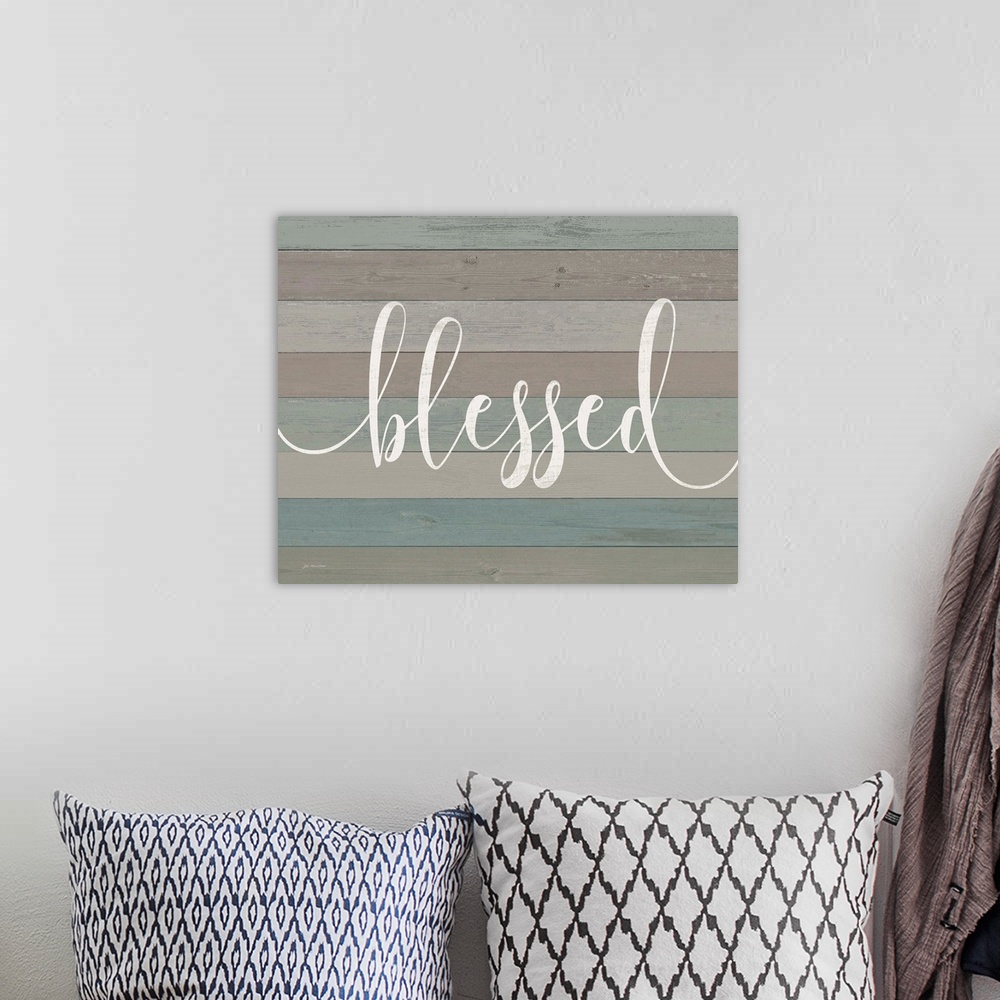 A bohemian room featuring "Blessed" against blue and gray shiplap wood background.