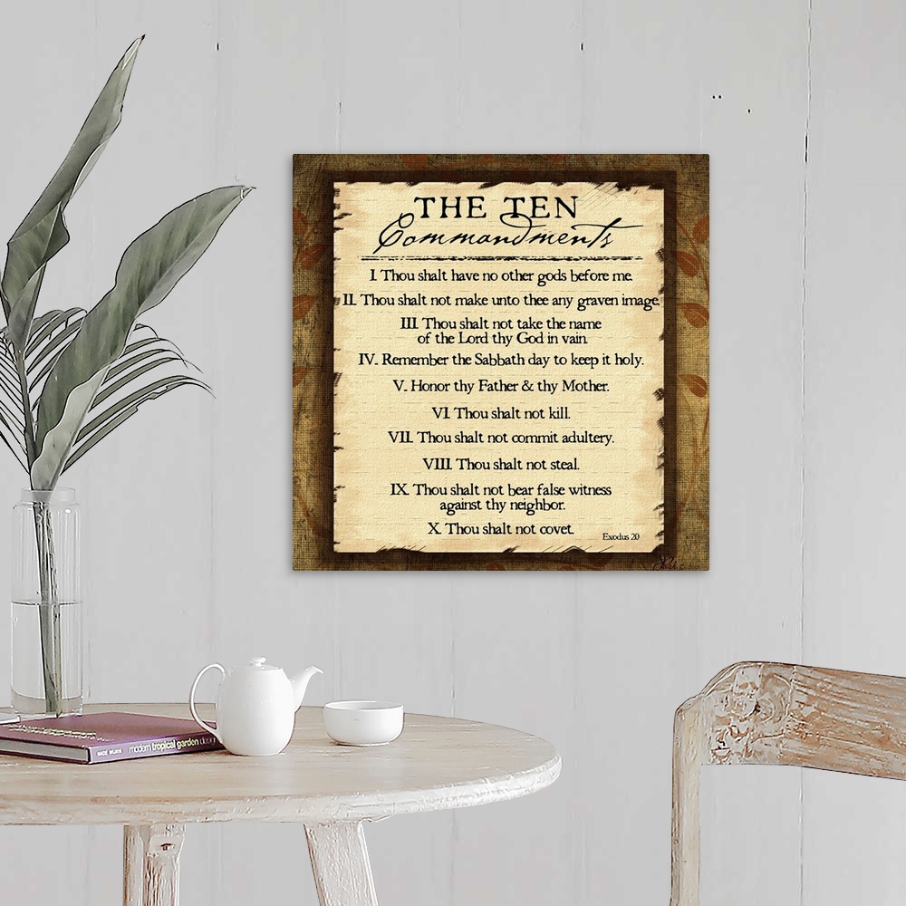 A farmhouse room featuring This large square piece lists the ten commandments with a decorative border around them.