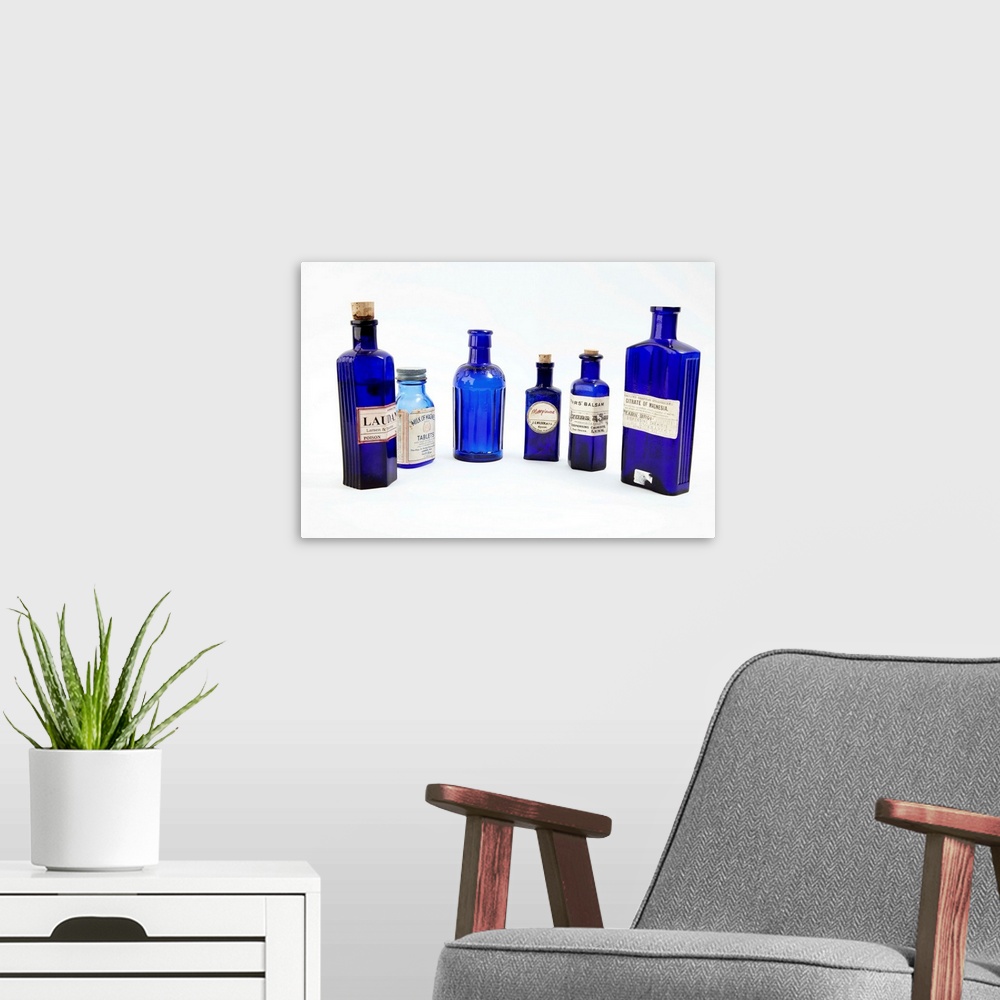 A modern room featuring Antique pharmacy bottles.