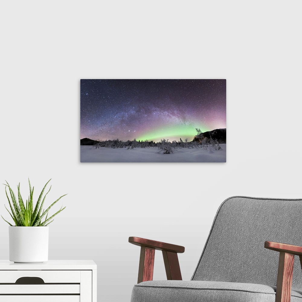 A modern room featuring Aurora borealis and Milky Way. View of the aurora borealis (northern lights) and the Milky Way ov...