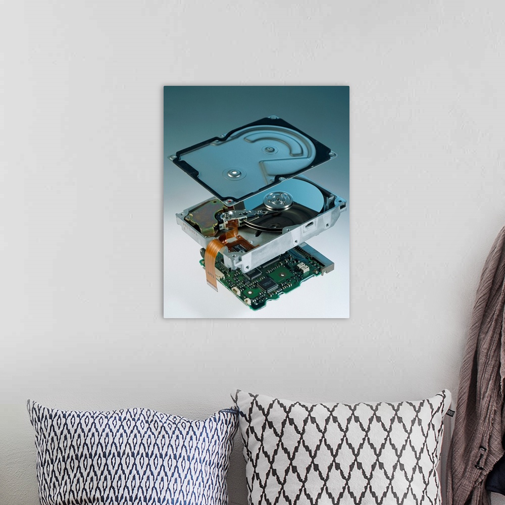 A bohemian room featuring Computer hard disk assembly. Component parts of a hard disk showing the outer aluminium casing (t...