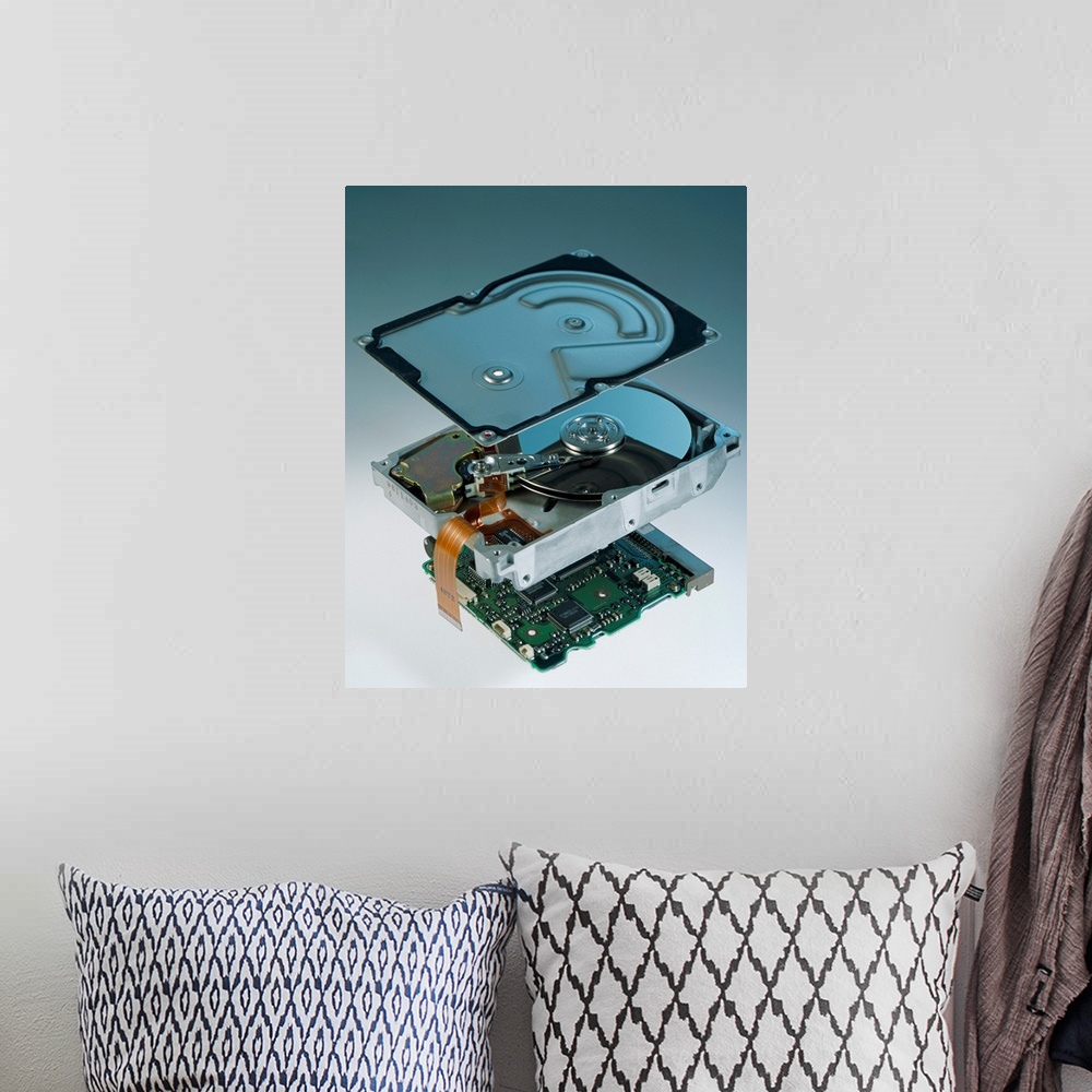 A bohemian room featuring Computer hard disk assembly. Component parts of a hard disk showing the outer aluminium casing (t...