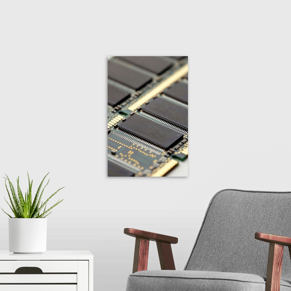 A modern room featuring Computer memory chips. RAM (random access memory) chips (grey) on two circuit boards from a compu...