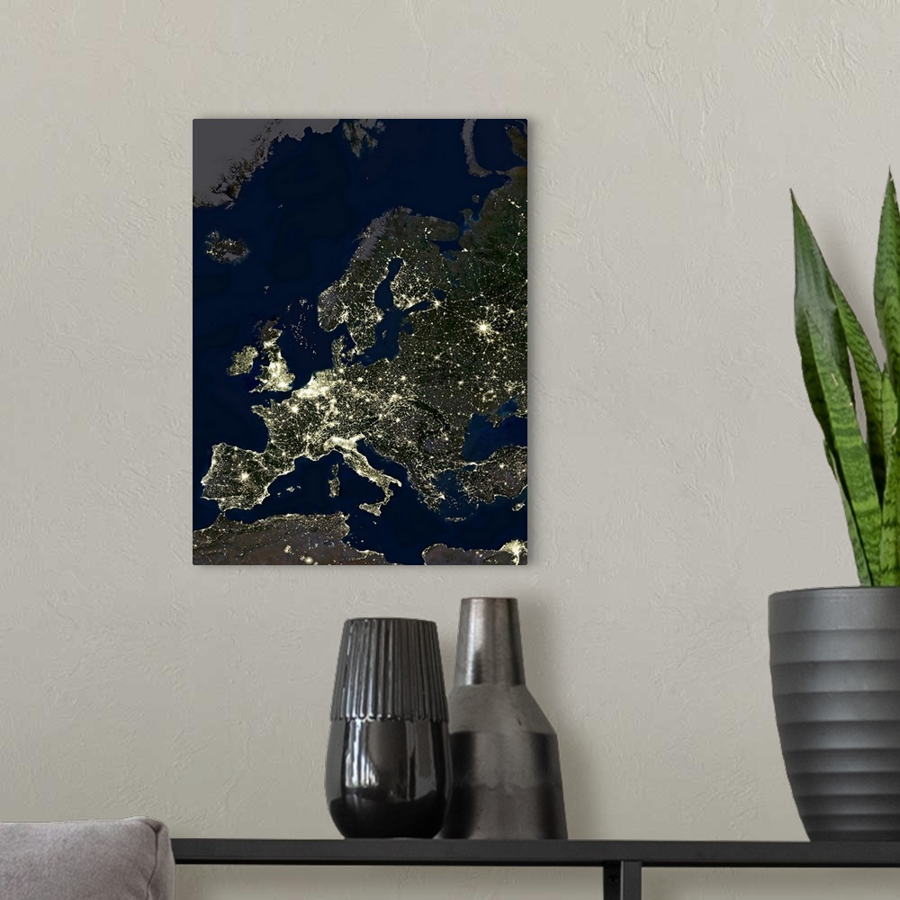 A modern room featuring Europe at night, satellite image. City lights (yellow) of increasing intensity show areas of incr...