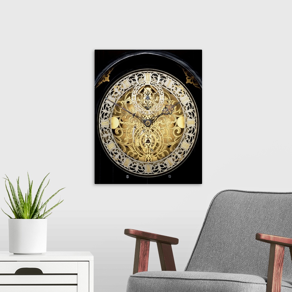 A modern room featuring Antique clock. Face of an antique skeleton clock, revealing the internal gearing. The main face s...