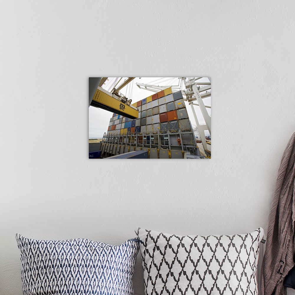 A bohemian room featuring Loading cargo containers. Crane being used to load a cargo container (left) onto a container ship...