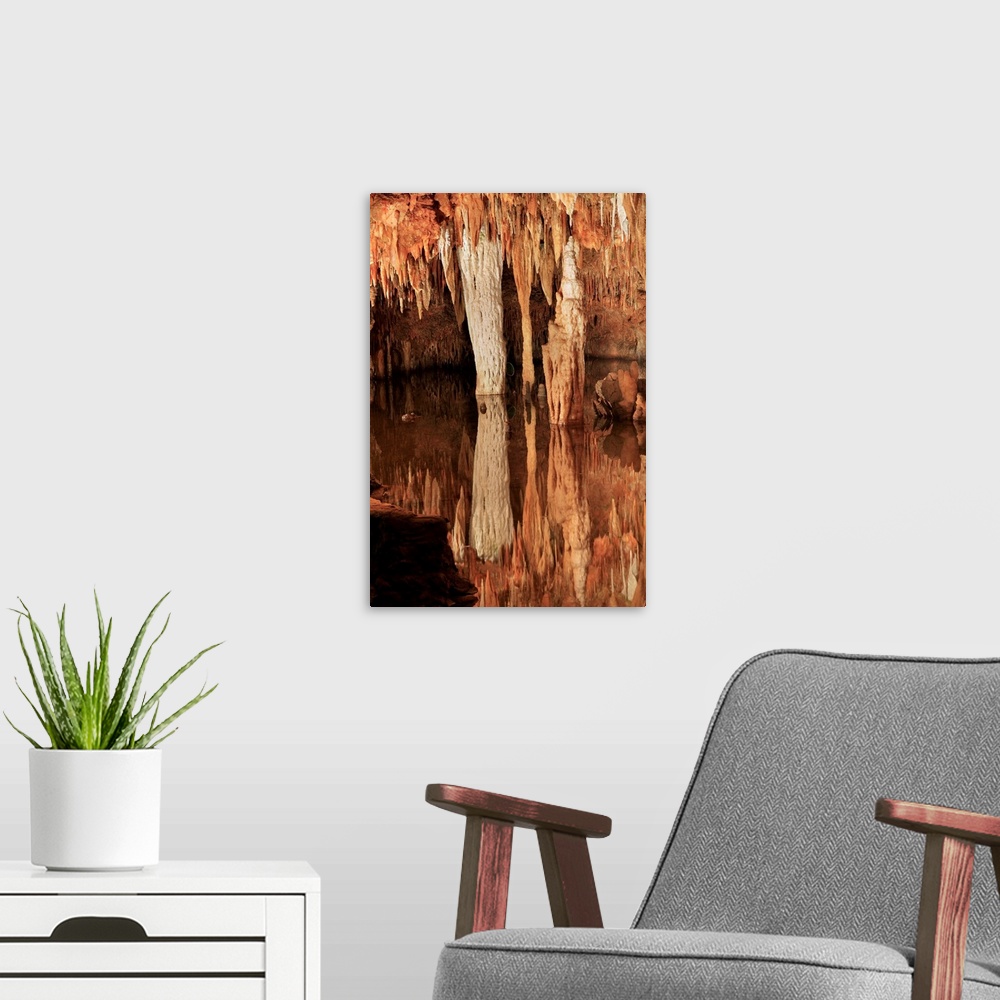 A modern room featuring Meramec Caverns. Limestone pillars, stalagtites and stalagmites by an underground stream. The Mer...