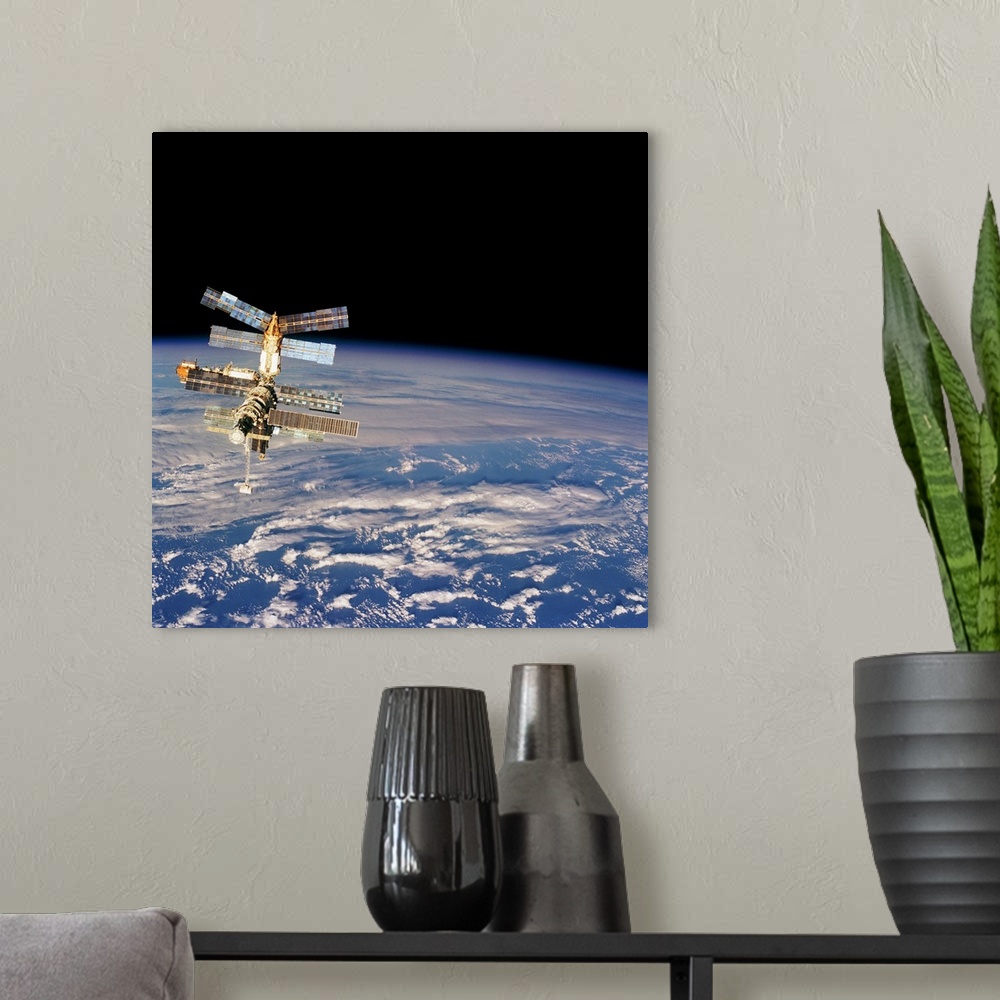 A modern room featuring Mir Space Station from Space Shuttle. Image taken from the aft flight deck of the Space Shuttle A...