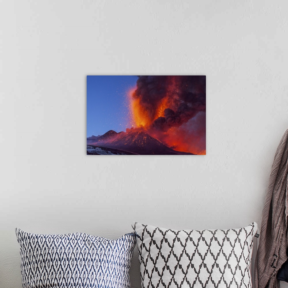 A bohemian room featuring Mount Etna erupting, 2012. Mount Etna is an active stratovolcano on the east coast of Sicily, Ita...