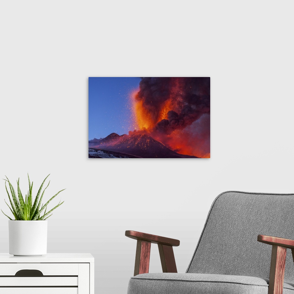 A modern room featuring Mount Etna erupting, 2012. Mount Etna is an active stratovolcano on the east coast of Sicily, Ita...
