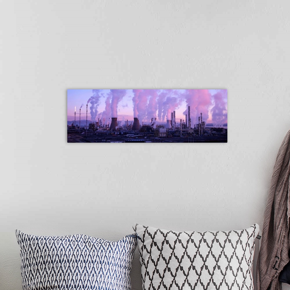 A bohemian room featuring Petrochemical plant at dawn, with clouds of smoke and steam rising from its smokestacks and cooli...