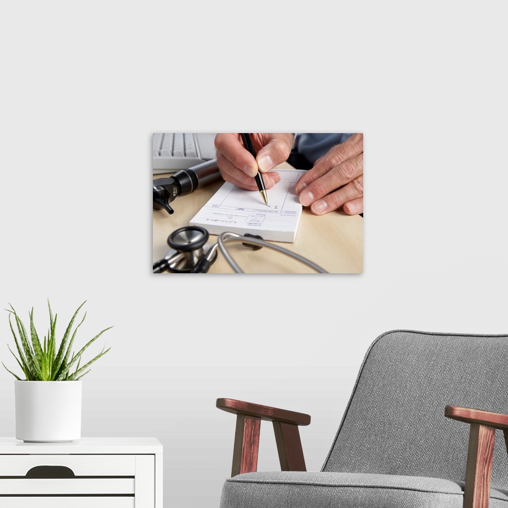 A modern room featuring MODEL RELEASED. Prescription. General practice doctor writing a prescription.