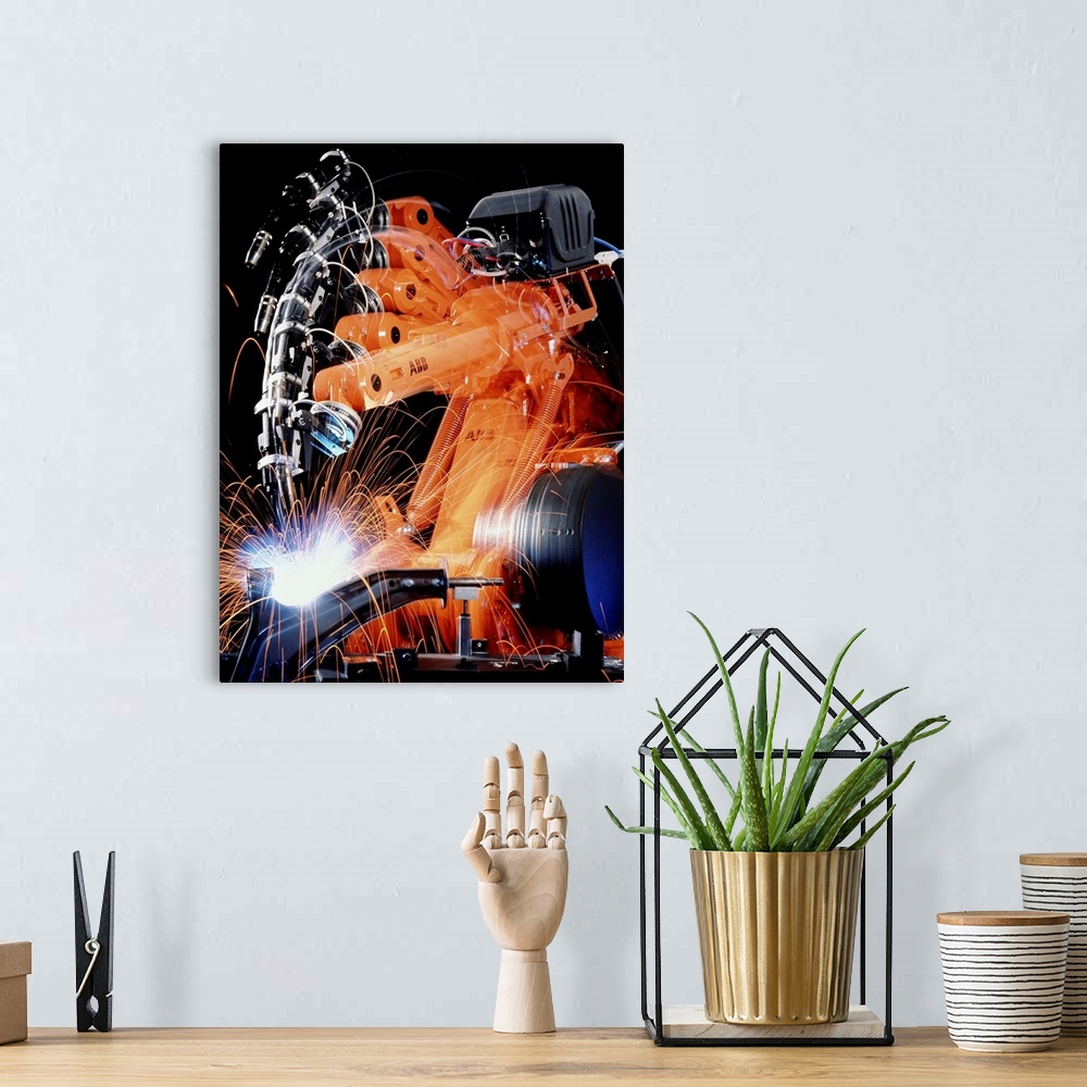 A bohemian room featuring Robot welding in car production. Multiple exposure image of a robot arm spot-welding the suspensi...