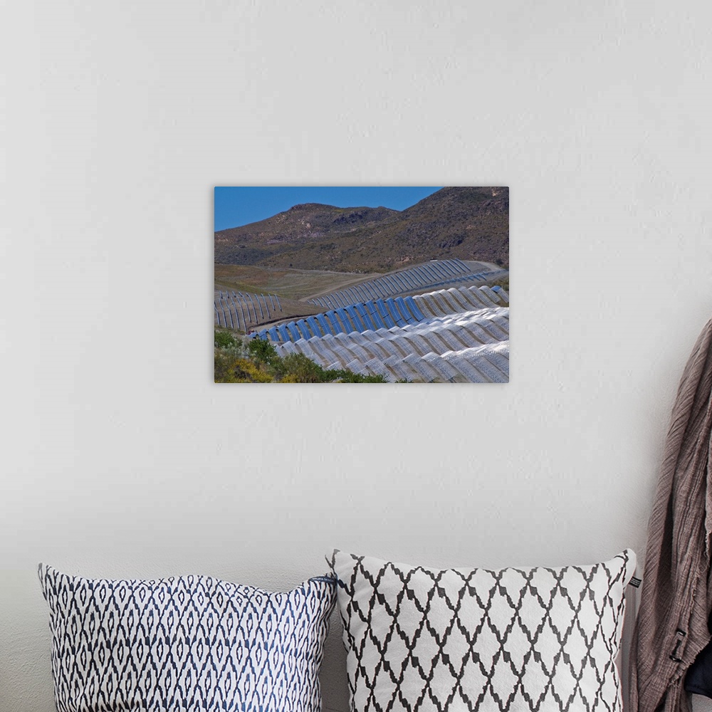 A bohemian room featuring Solar power plant. Array of solar cells at a solar power plant in Cala San Pedro, Spain.