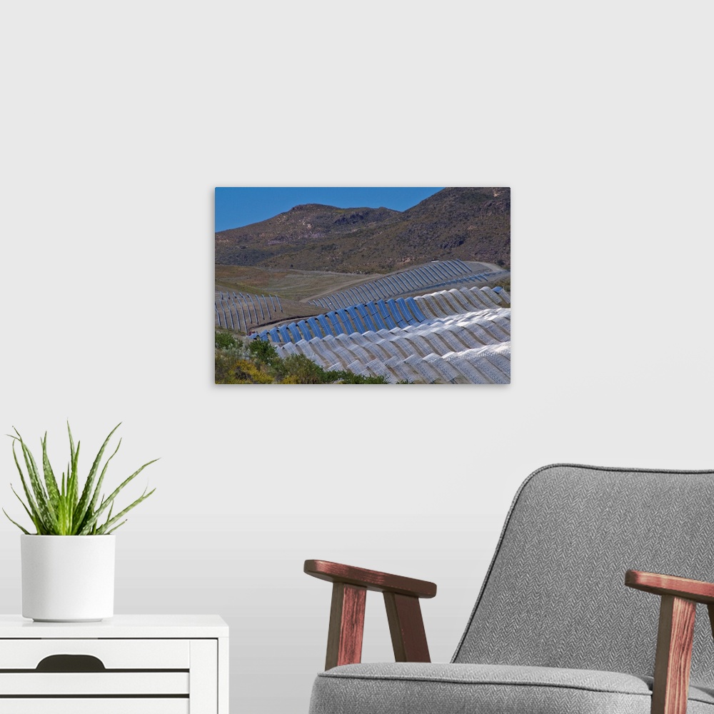 A modern room featuring Solar power plant. Array of solar cells at a solar power plant in Cala San Pedro, Spain.