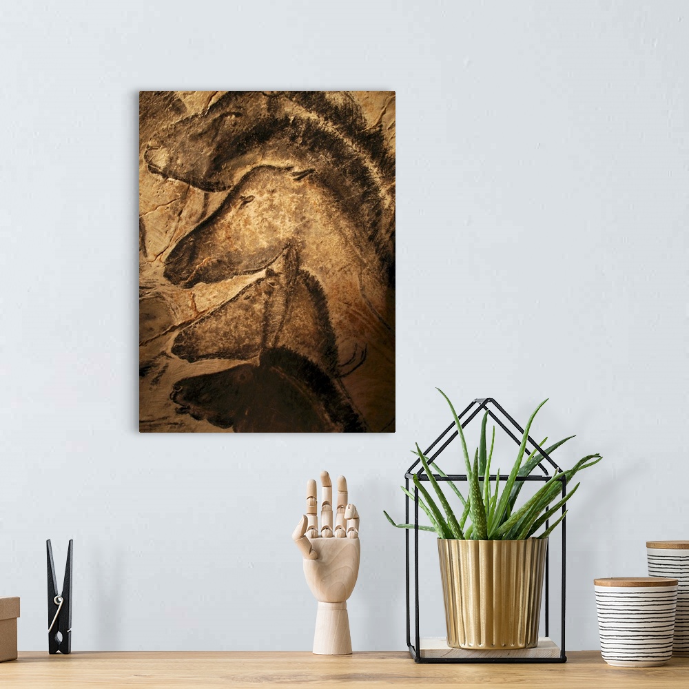 A bohemian room featuring Stone-age cave paintings. Artwork of horses painted on the wall of a cave. These paintings are fo...
