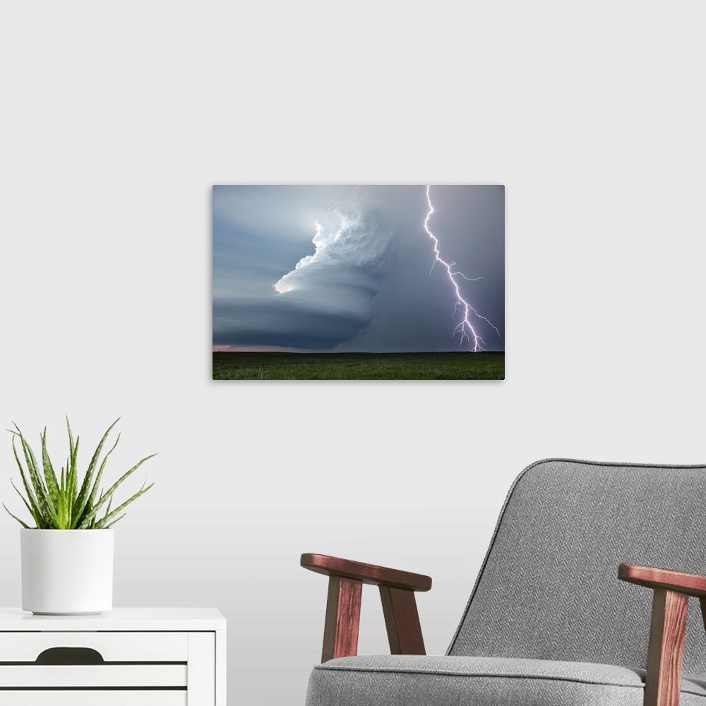 A modern room featuring Supercell thunderstorm and lightning strike over rural Nebraska, USA. A supercell thunderstorm is...