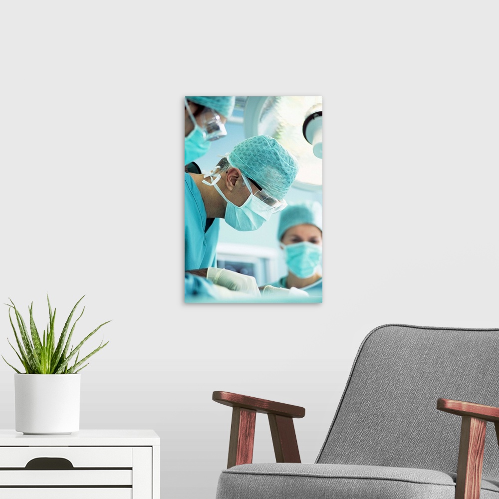 A modern room featuring MODEL RELEASED. Surgeon performing an operation.