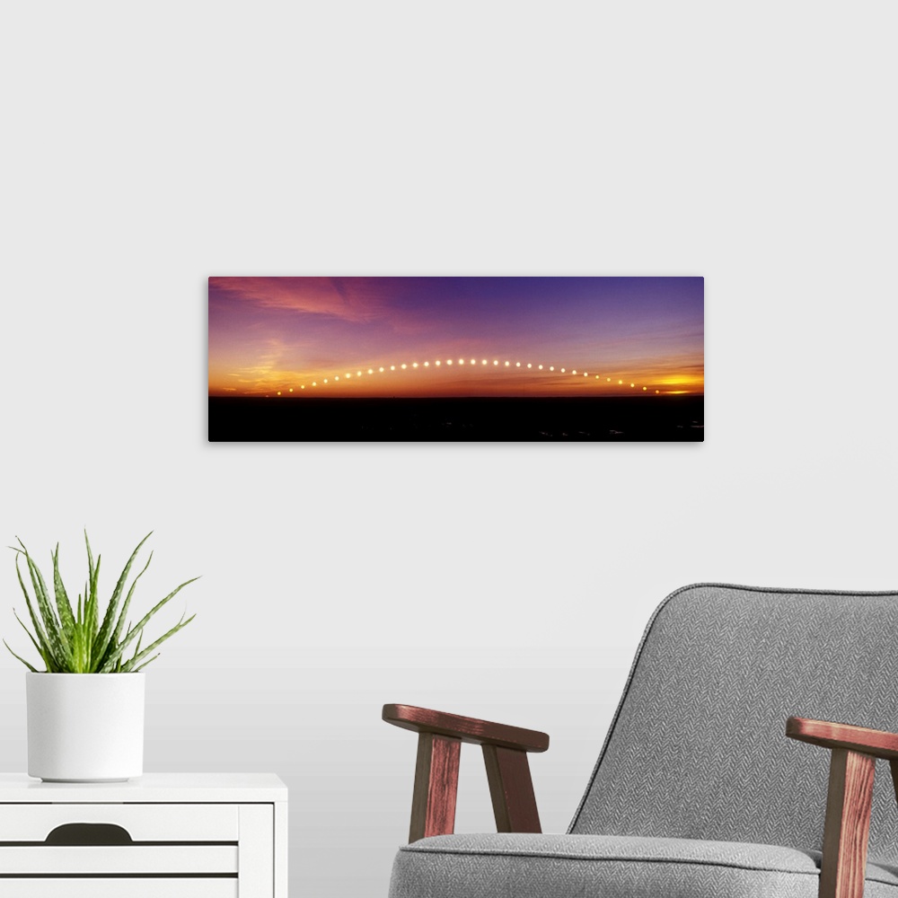 A modern room featuring Time-lapse image of a suntrail. Time-lapse exposure showing the path of the sun as it rises from ...