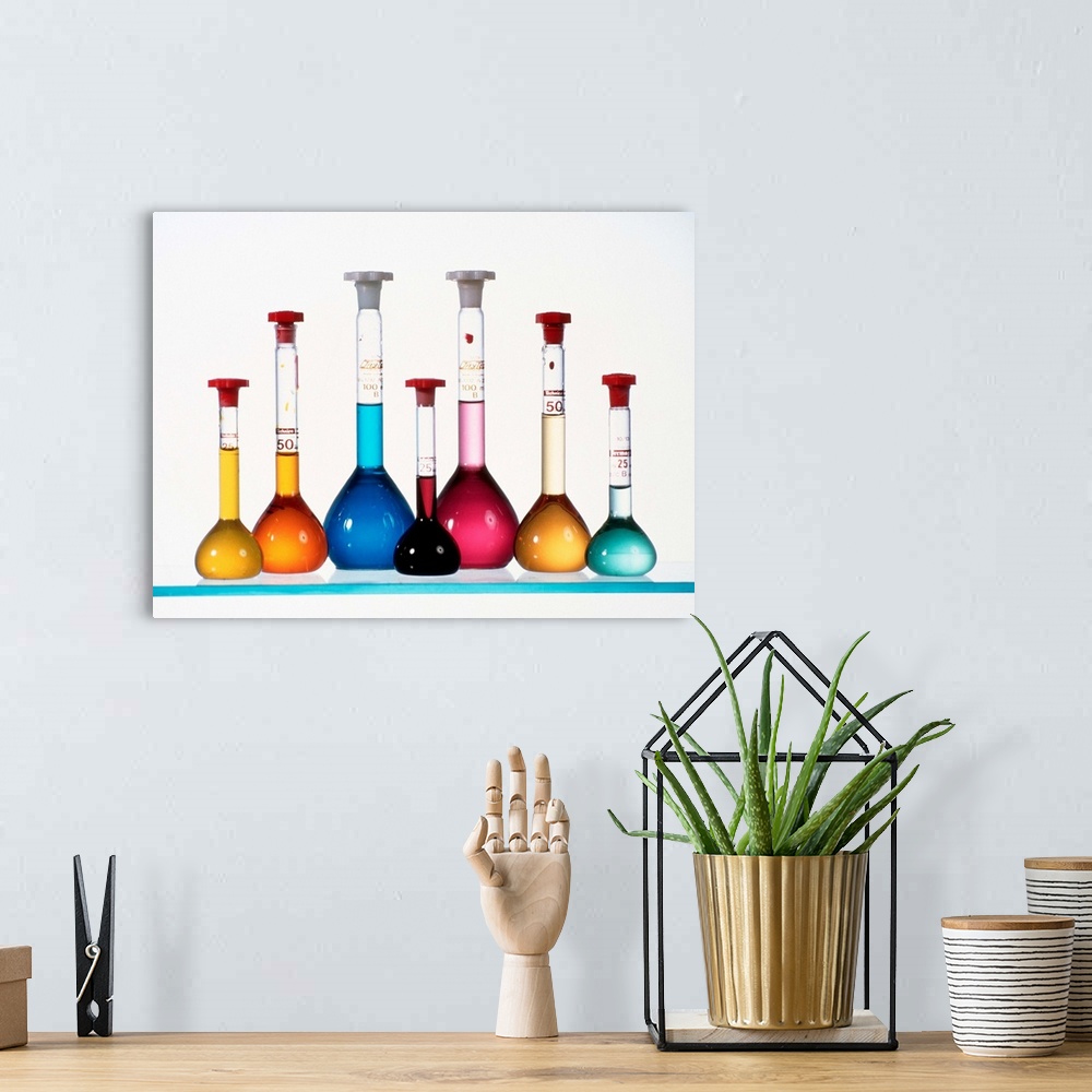 A bohemian room featuring Transition metal compound solutions. The volumetric flasks contain dissolved transition metal com...