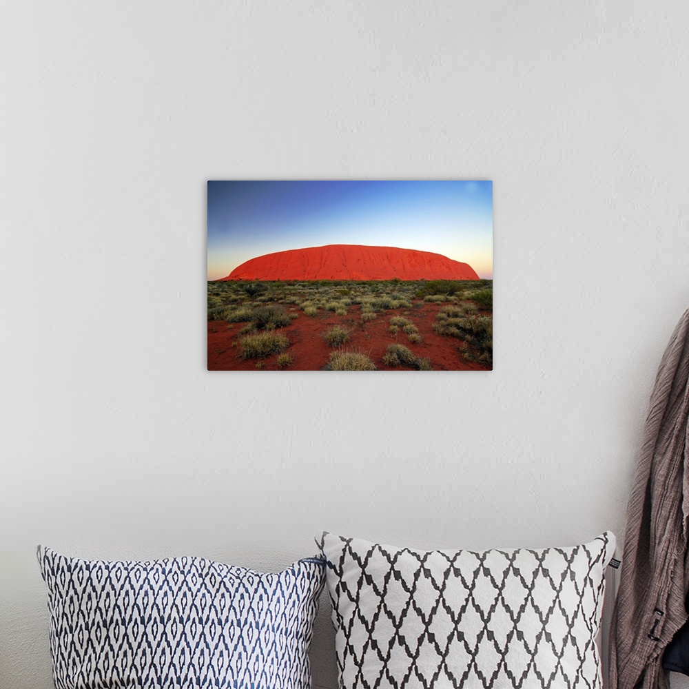 A bohemian room featuring Uluru (Ayers Rock) at sunrise. Uluru is a large sandstone rock formation in the southern part of ...
