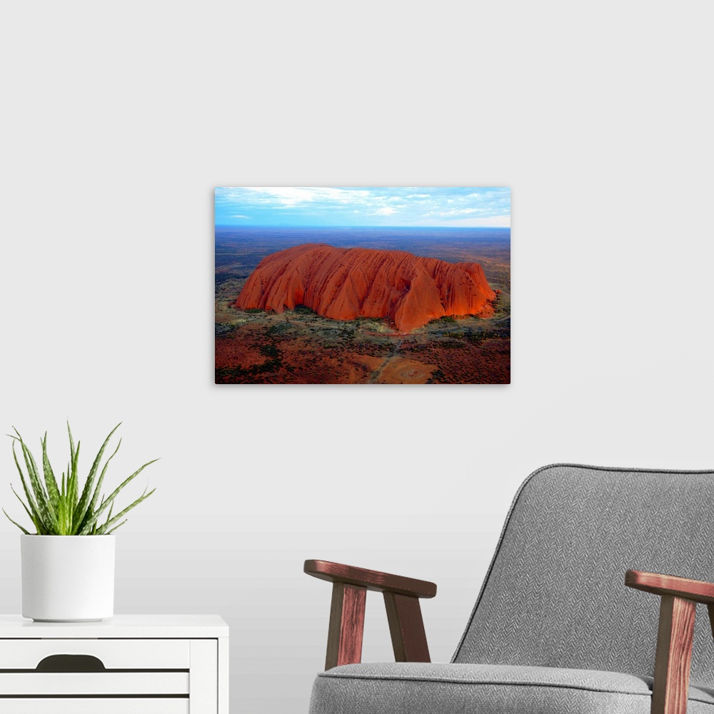 A modern room featuring Uluru (Ayers Rock) at sunset. Uluru is a large sandstone rock formation in the southern part of t...