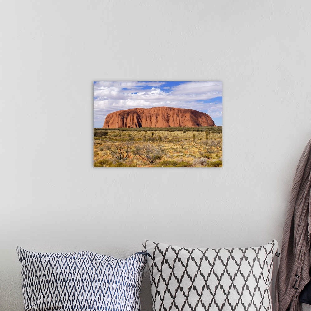 A bohemian room featuring Uluru (Ayers Rock) in the morning. Uluru is a large sandstone rock formation in the southern part...
