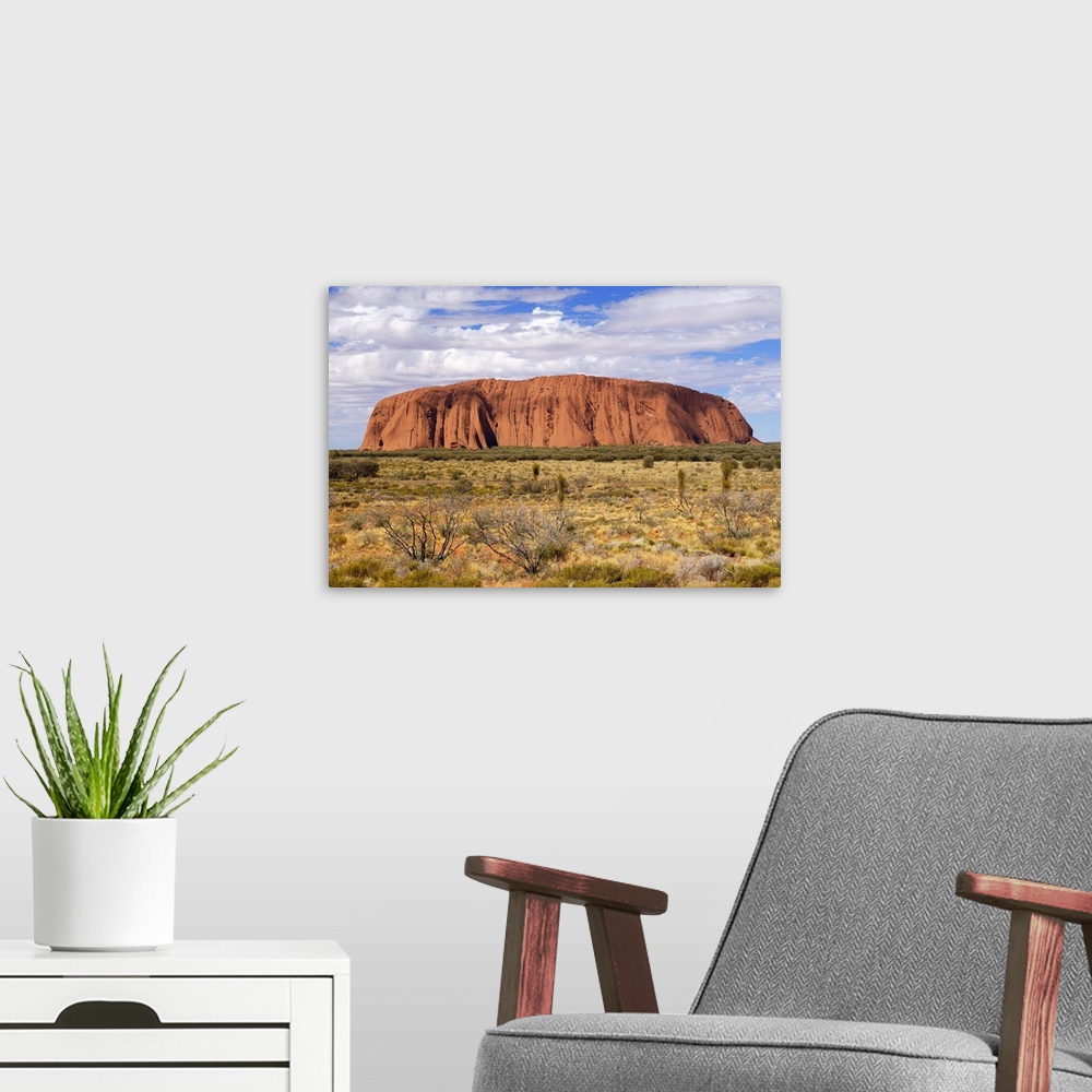 A modern room featuring Uluru (Ayers Rock) in the morning. Uluru is a large sandstone rock formation in the southern part...