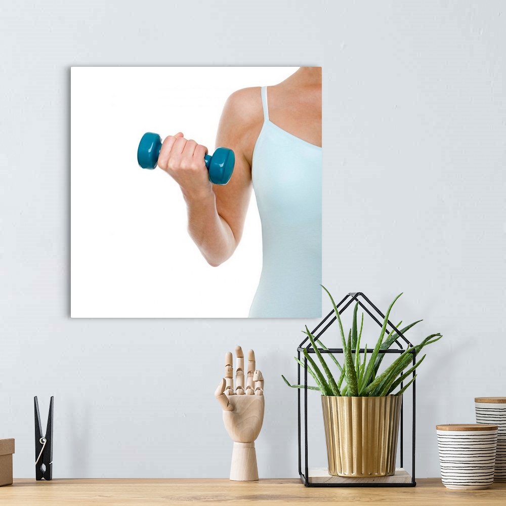 A bohemian room featuring MODEL RELEASED. Woman lifting weights.