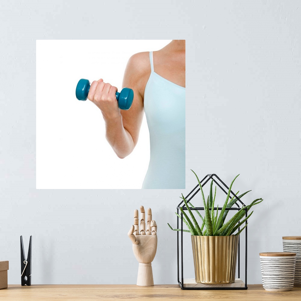 A bohemian room featuring MODEL RELEASED. Woman lifting weights.
