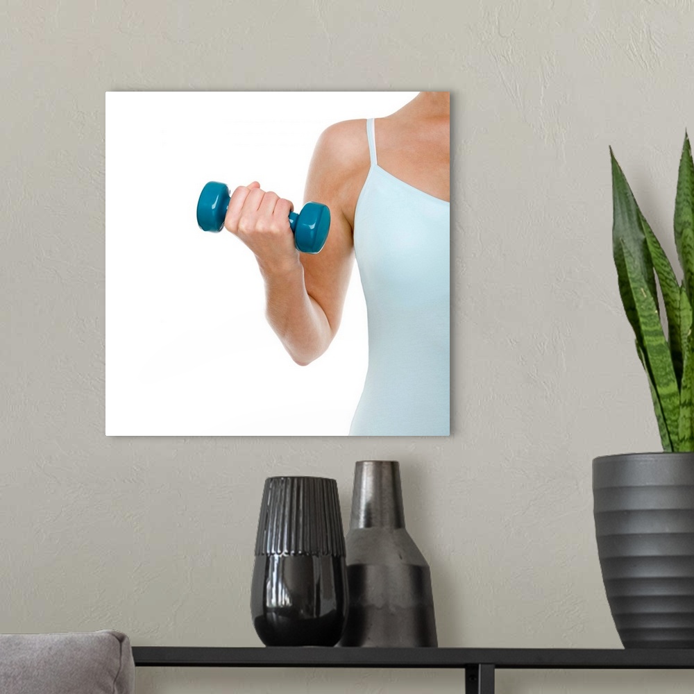 A modern room featuring MODEL RELEASED. Woman lifting weights.