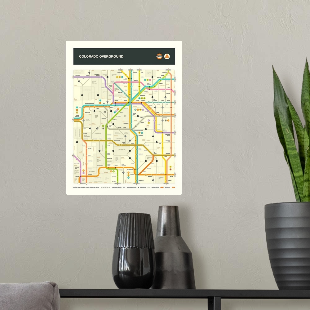 A modern room featuring Illustrated map of the Colorado state highways with labels and a key at the bottom.