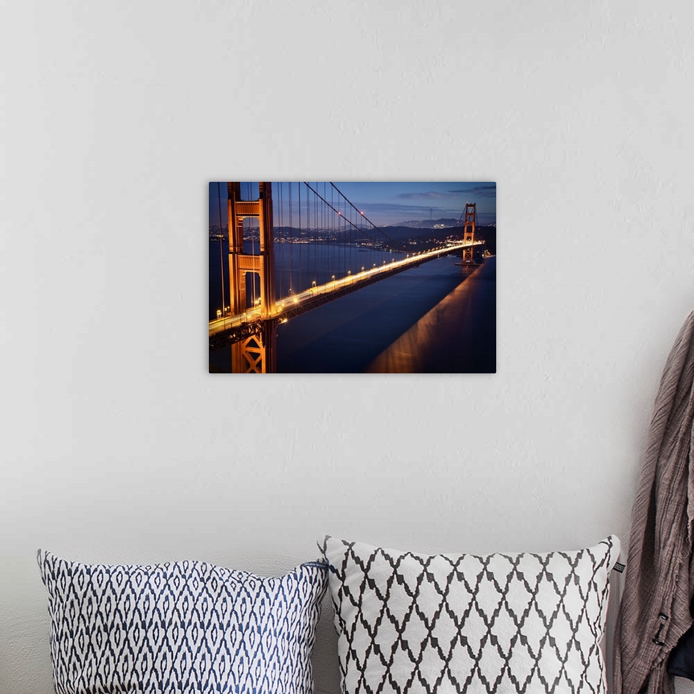 A bohemian room featuring Aerial photograph of the famous Golden Gate Bridge in the evening, glowing with light trails from...