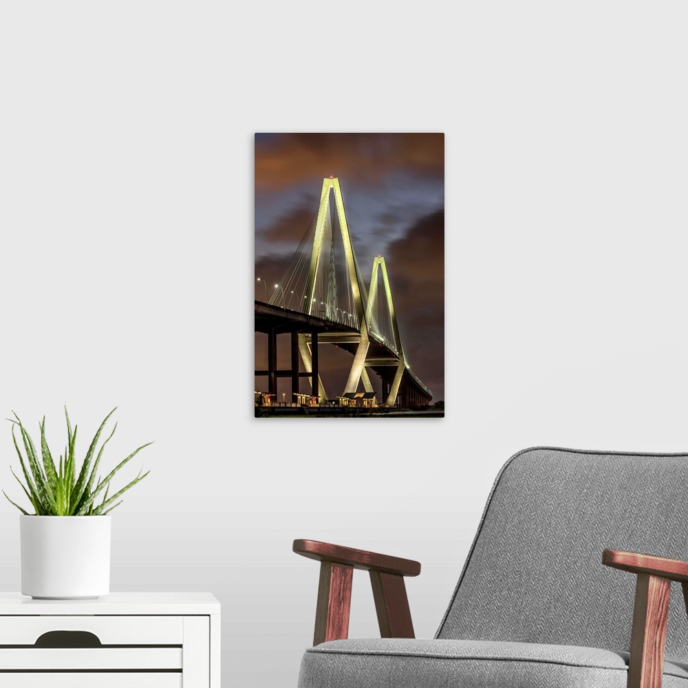 A modern room featuring Arthur Ravenel Jr. Bridge crossing the Cooper River at twilight.
