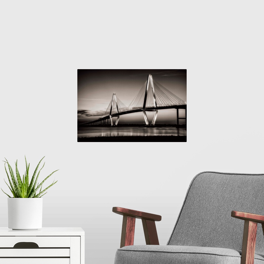 A modern room featuring Arthur Ravenel Jr. Bridge crossing the Cooper River at twilight.