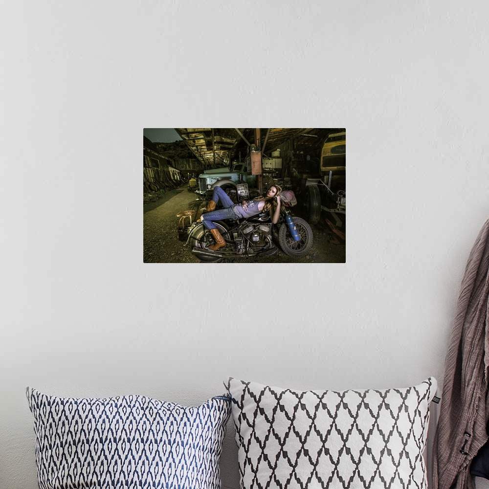 A bohemian room featuring Sexy blond laying on an old Harley Davidson