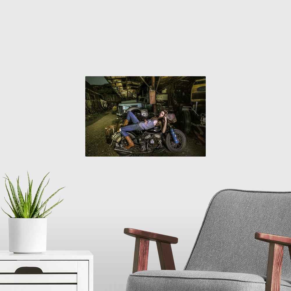 A modern room featuring Sexy blond laying on an old Harley Davidson