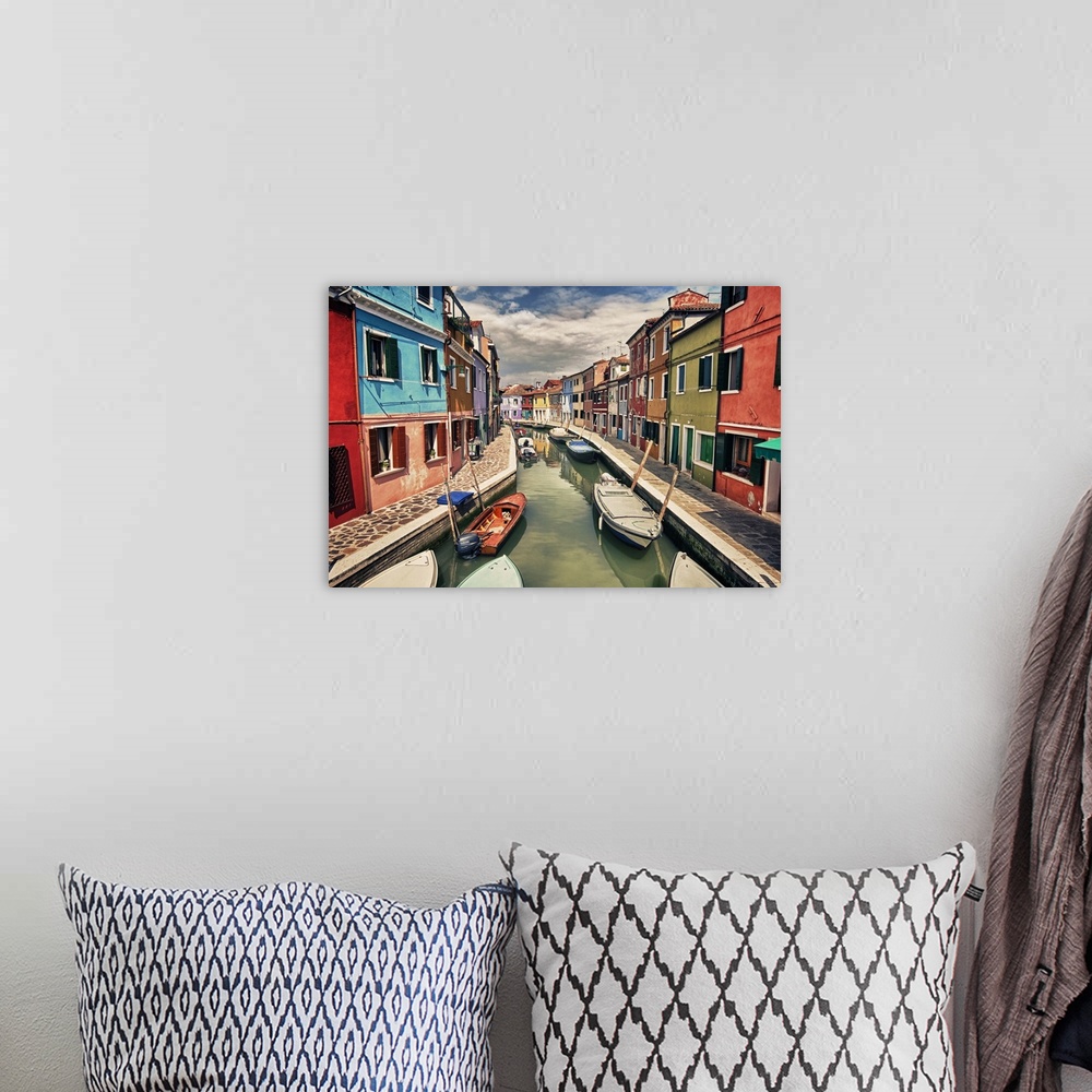 A bohemian room featuring This landscape photograph shows a narrow canal lined with vividly colorful houses.