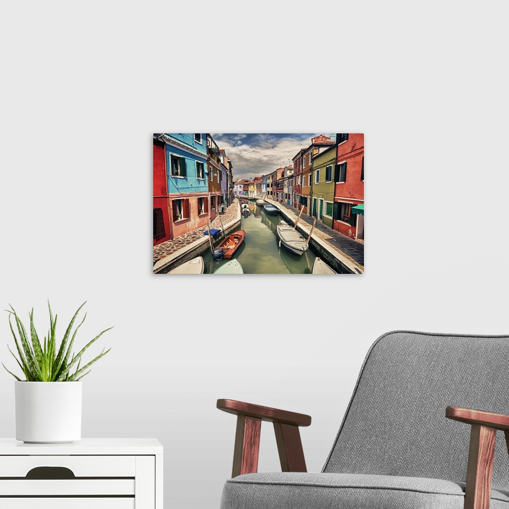 A modern room featuring This landscape photograph shows a narrow canal lined with vividly colorful houses.