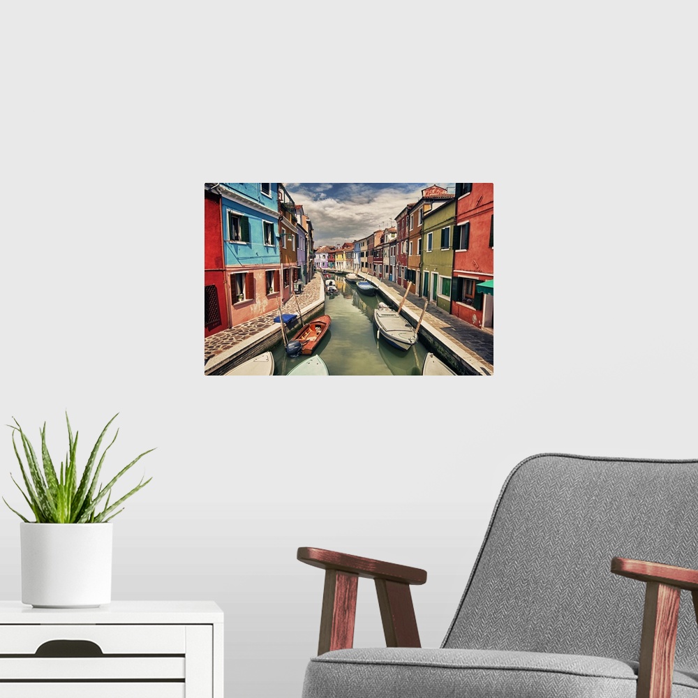 A modern room featuring This landscape photograph shows a narrow canal lined with vividly colorful houses.