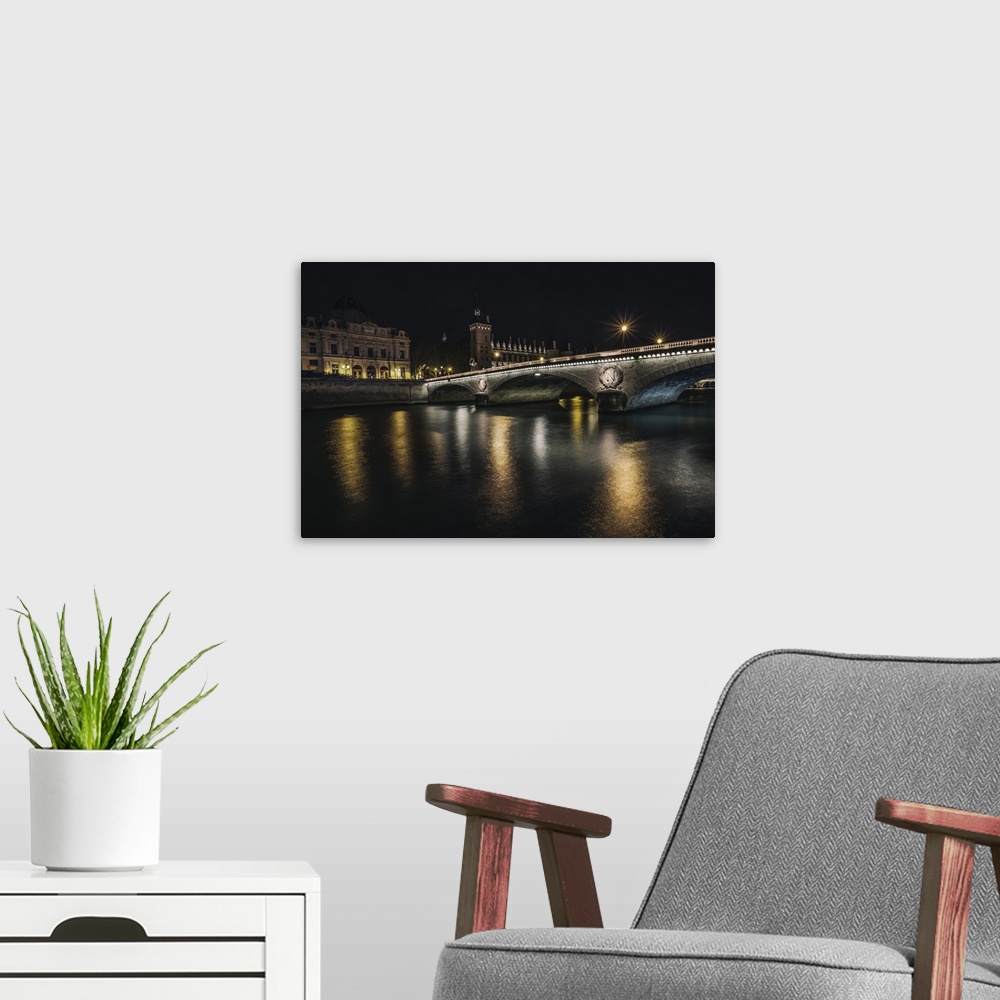 A modern room featuring Bridge across the Seine at night in Paris, France